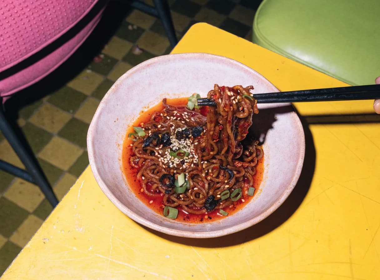 Bowl of crispy chili noodles with fresh garnish