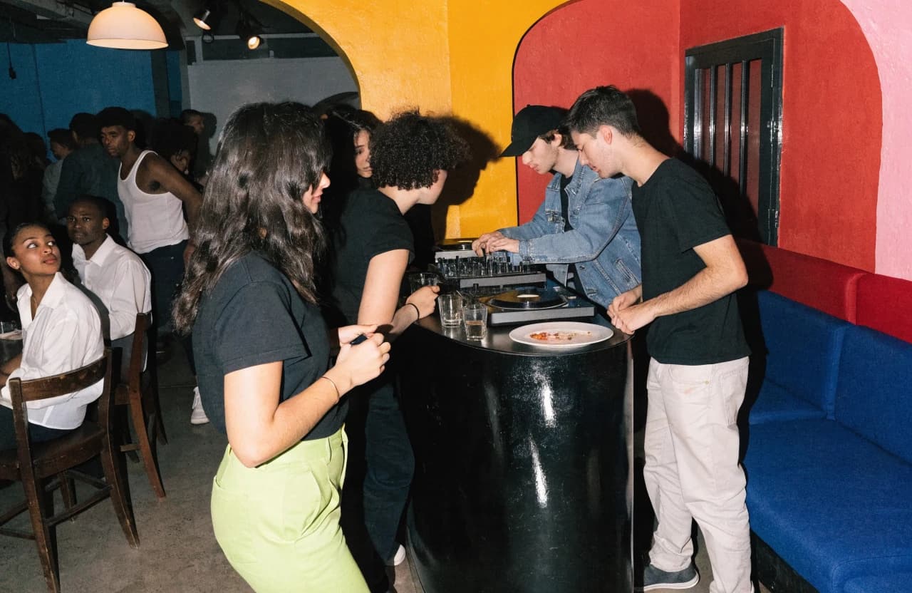 Restaurant social room with a DJ and evening crowd