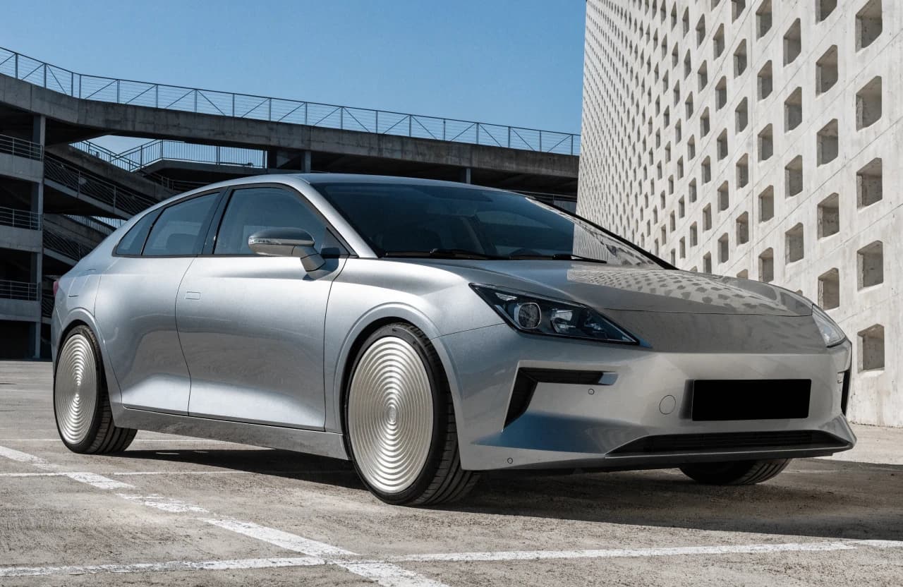 Dark compact sedan in a fictional dealership photo