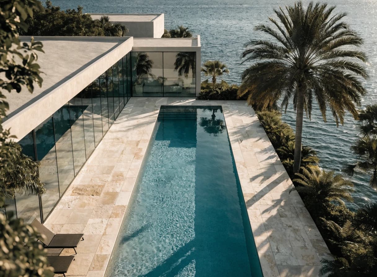 Waterfront modern pool with a broad architectural deck